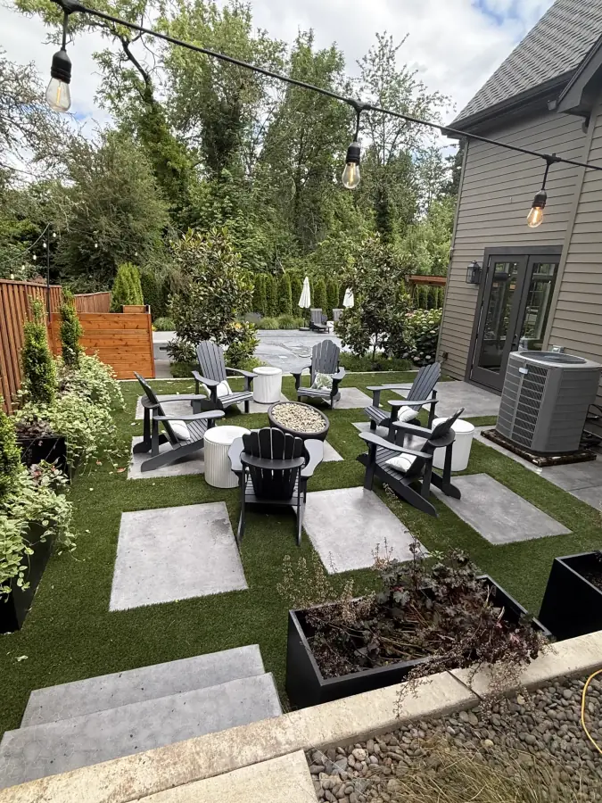 Architectural concrete pavers, synthetic turf courtyard, and outdoor firepit area by Rubi Construction LLC